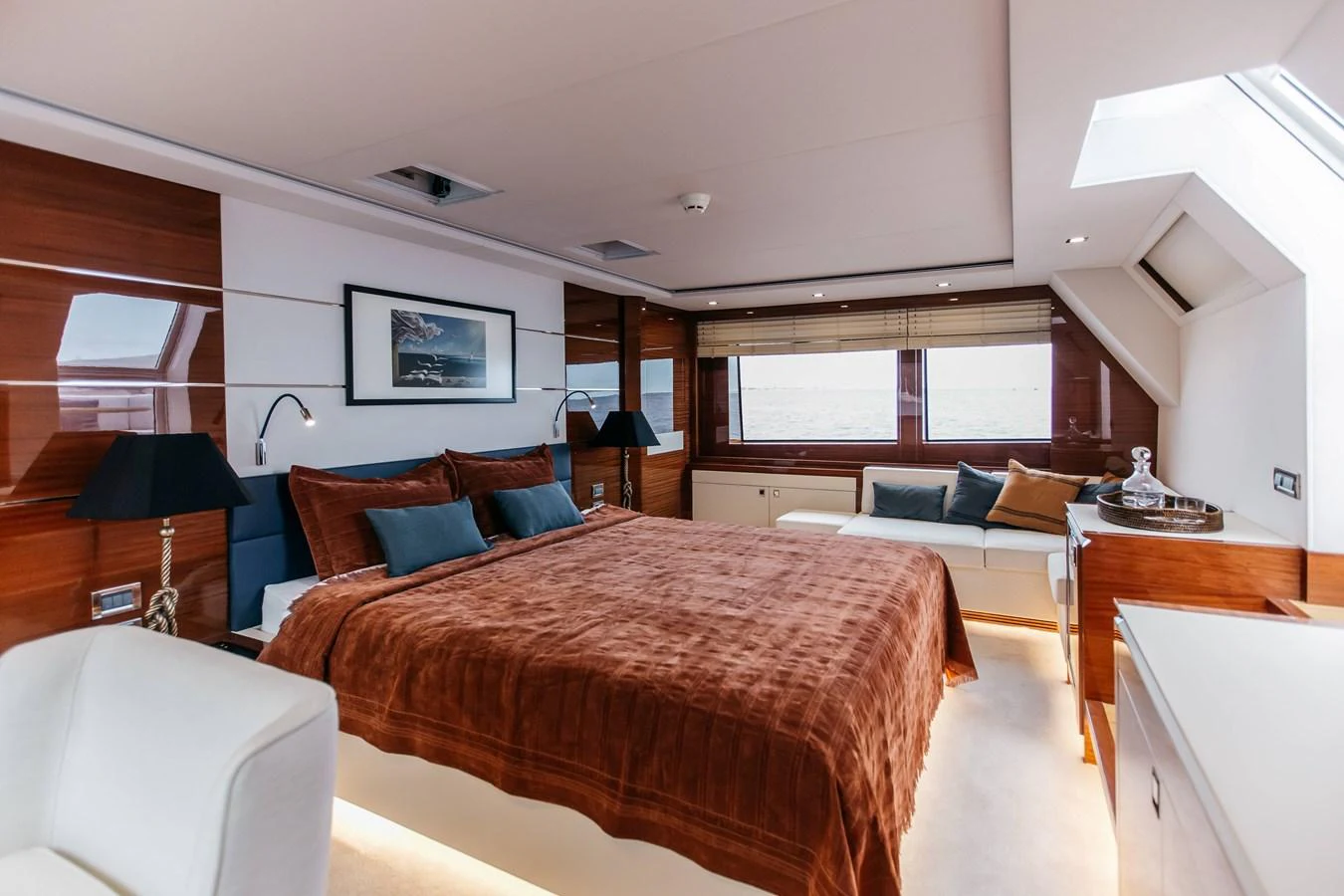 a bedroom with a bed and a desk aboard PAPILLON Yacht for Sale