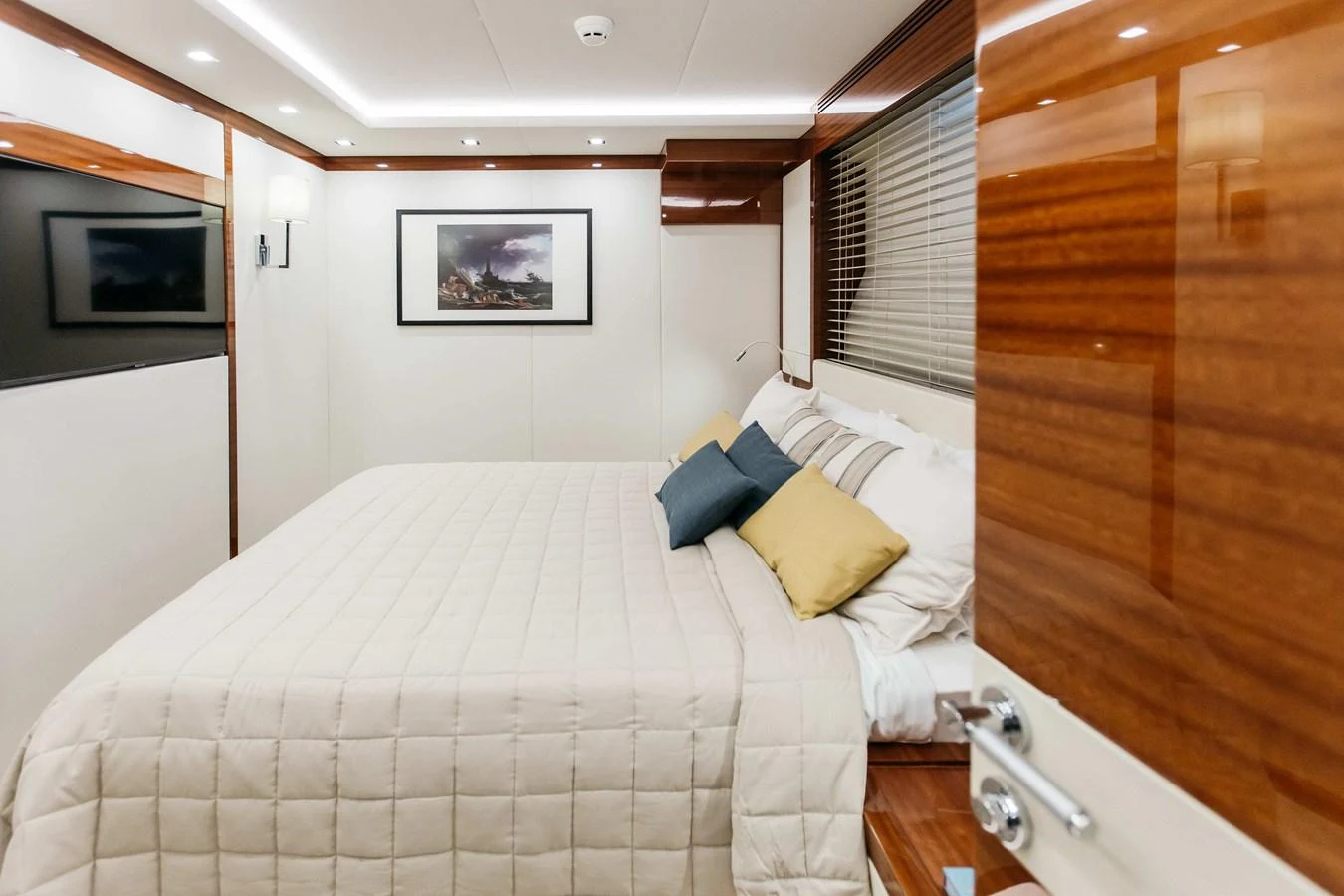 a bedroom with a bed and a television aboard PAPILLON Yacht for Sale