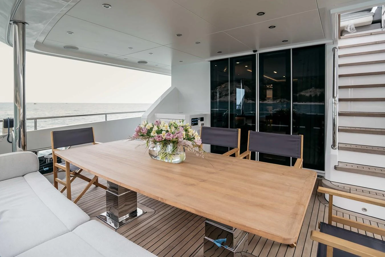 a large room with a table and chairs aboard PAPILLON Yacht for Sale
