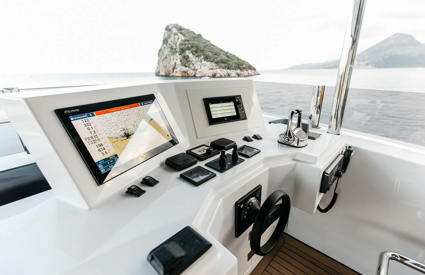 a white counter top with a map on it and a phone on it aboard PAPILLON Yacht for Sale