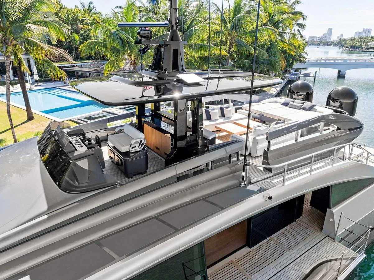 The yacht's sleek flybridge offers a luxurious outdoor space with ample seating and a modern helm station. aboard CAFFEINE Yacht for Sale
