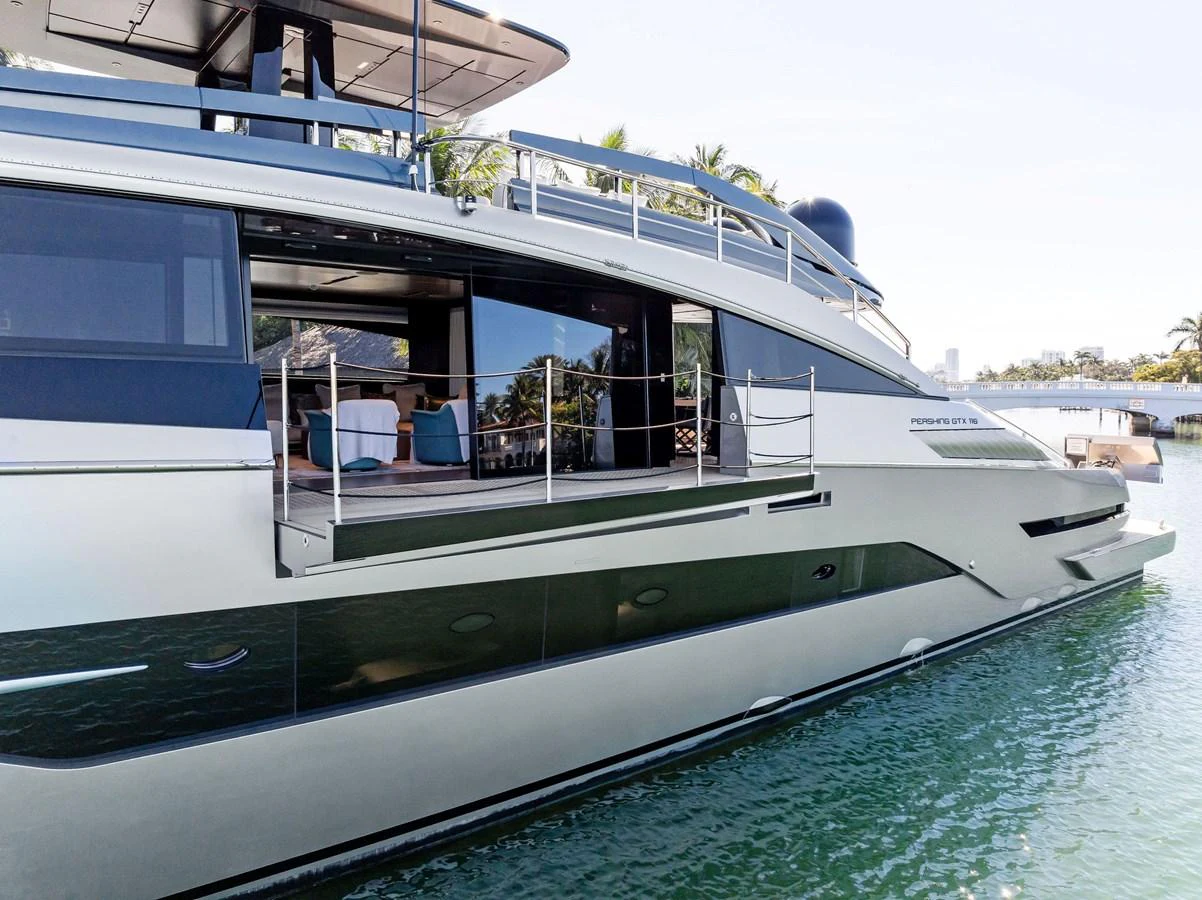 A sleek and modern yacht with an open side deck, showcasing luxurious interior spaces and elegant design. aboard CAFFEINE Yacht for Sale