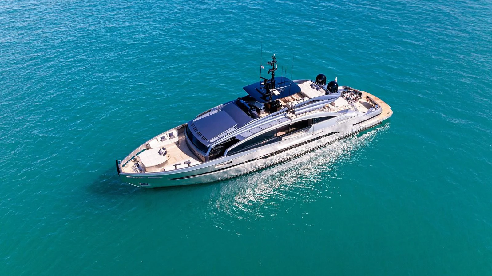 A sleek and modern yacht cruising on calm turquoise waters. aboard CAFFEINE Yacht for Sale