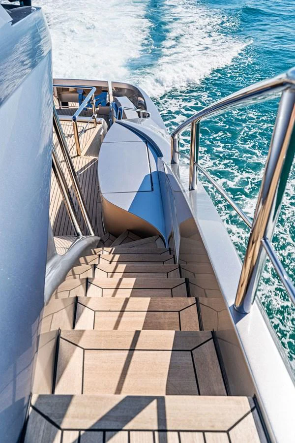 A sleek staircase leads down to the aft deck, showcasing the yacht's elegant design and craftsmanship. aboard CAFFEINE Yacht for Sale