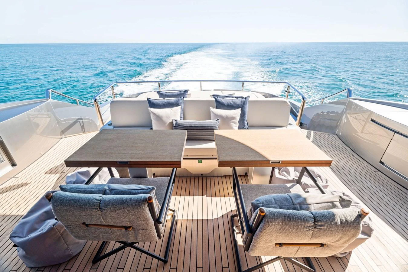 The aft deck offers a luxurious outdoor seating area with stunning ocean views. aboard CAFFEINE Yacht for Sale