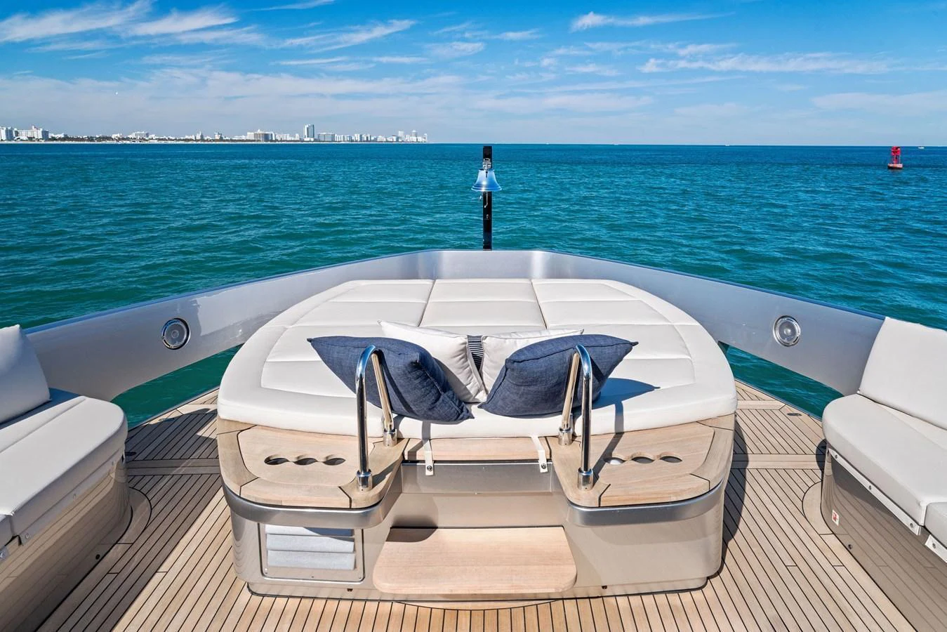 The aft deck features a luxurious sunbathing area with plush cushions and stunning ocean views. aboard CAFFEINE Yacht for Sale