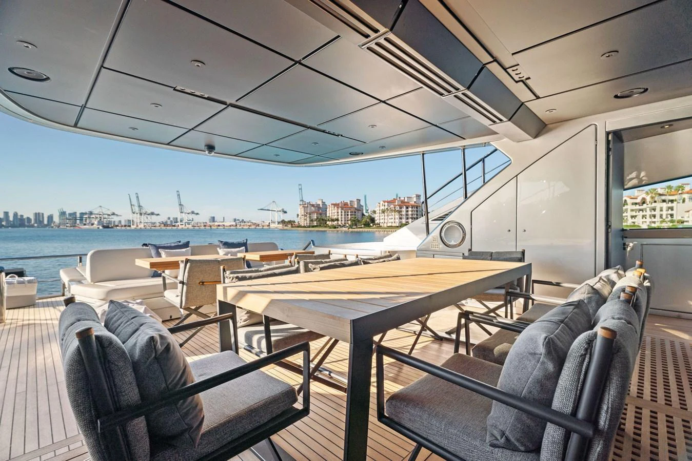 The aft deck features a spacious dining area with comfortable seating and stunning waterfront views. aboard CAFFEINE Yacht for Sale