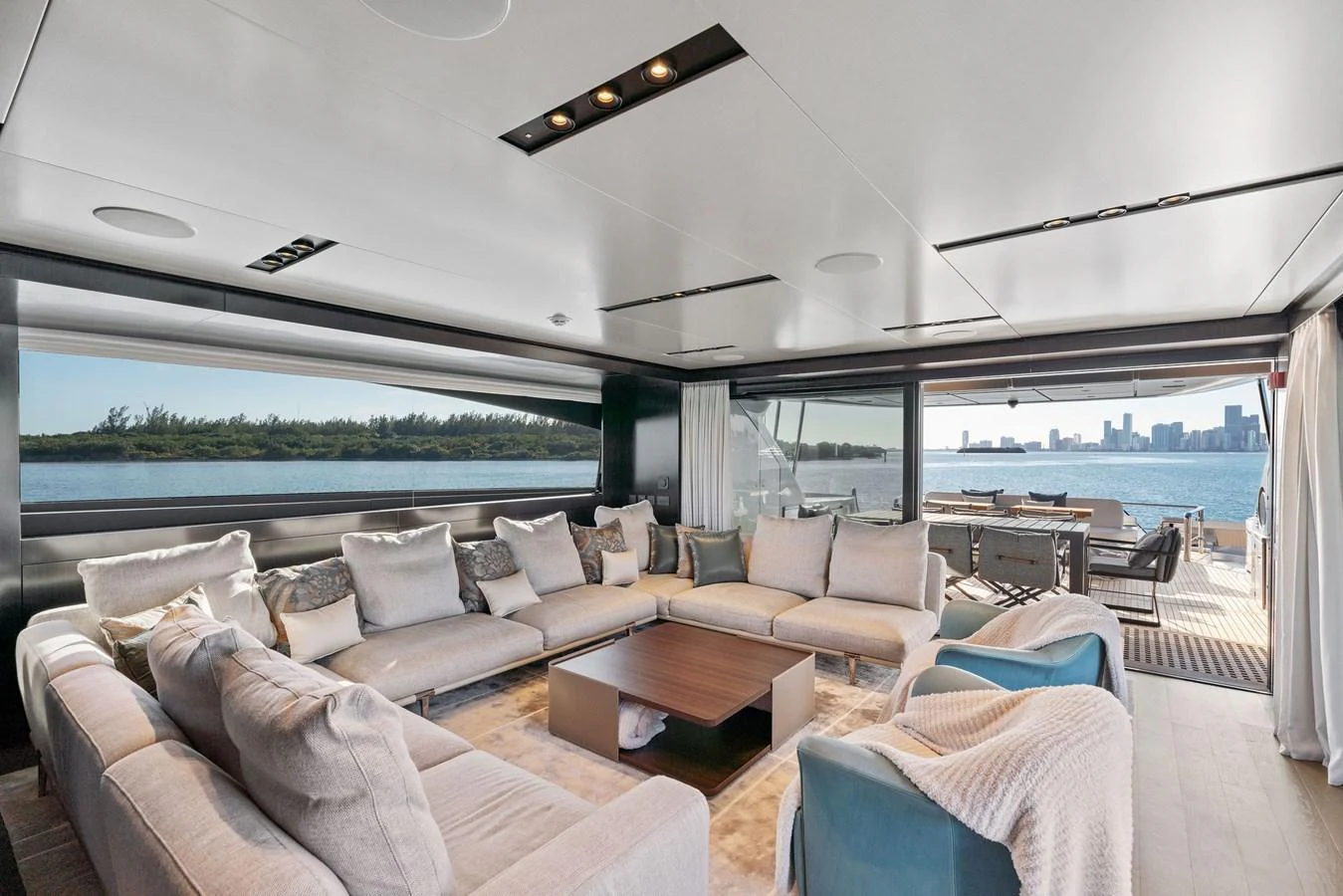 The spacious salon offers panoramic views and luxurious seating arrangements. aboard CAFFEINE Yacht for Sale