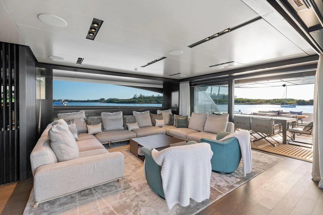 The salon offers a spacious and luxurious seating area with a stunning view of the water. aboard CAFFEINE Yacht for Sale