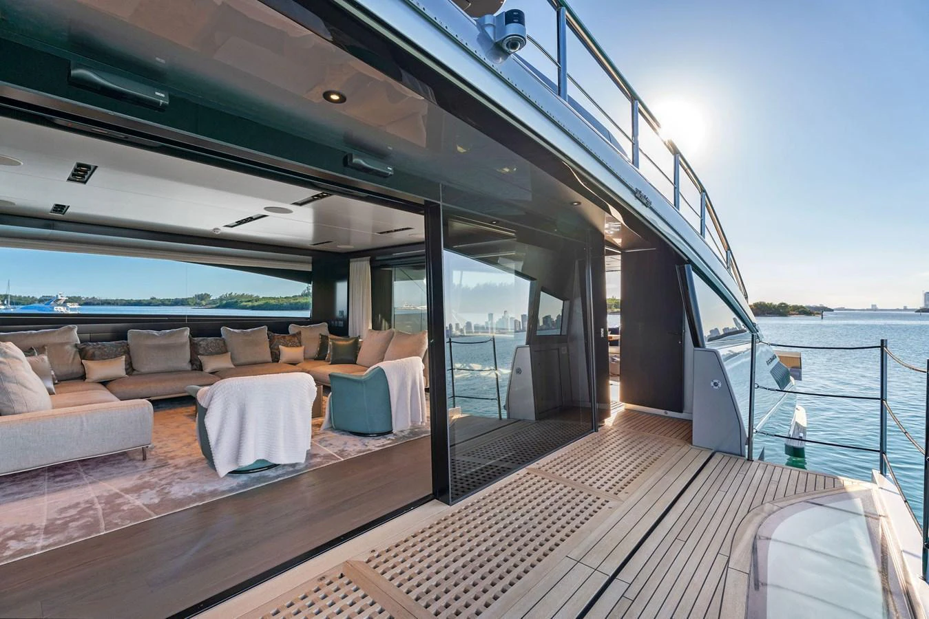 The aft deck features a spacious lounging area with plush seating and a seamless transition to the interior. aboard CAFFEINE Yacht for Sale