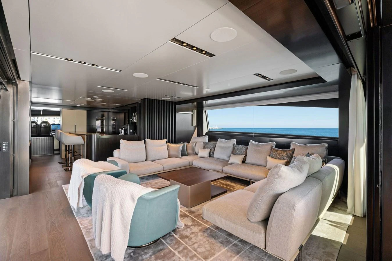 The salon features a spacious and luxurious seating area with panoramic ocean views. aboard CAFFEINE Yacht for Sale