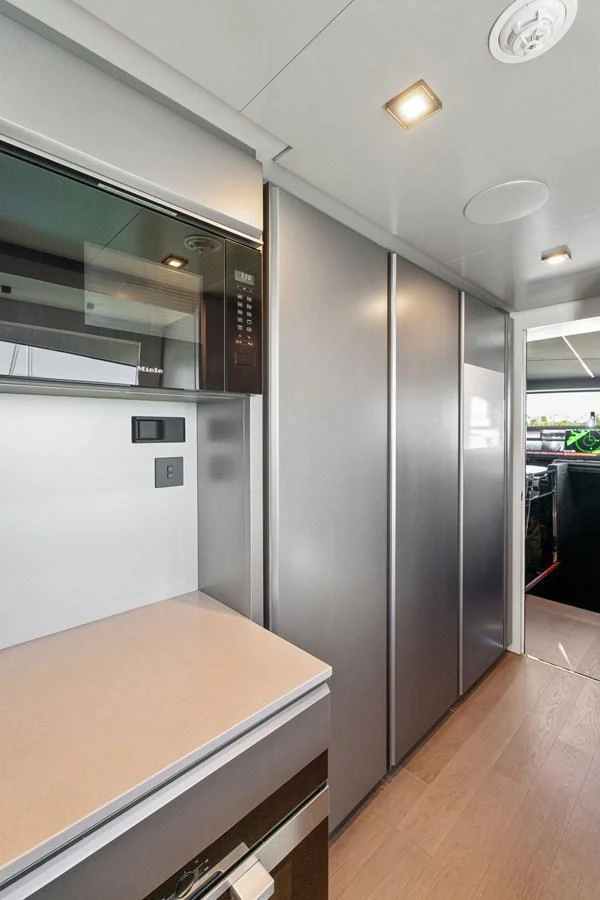 The sleek and modern galley features high-end appliances and ample storage space. aboard CAFFEINE Yacht for Sale