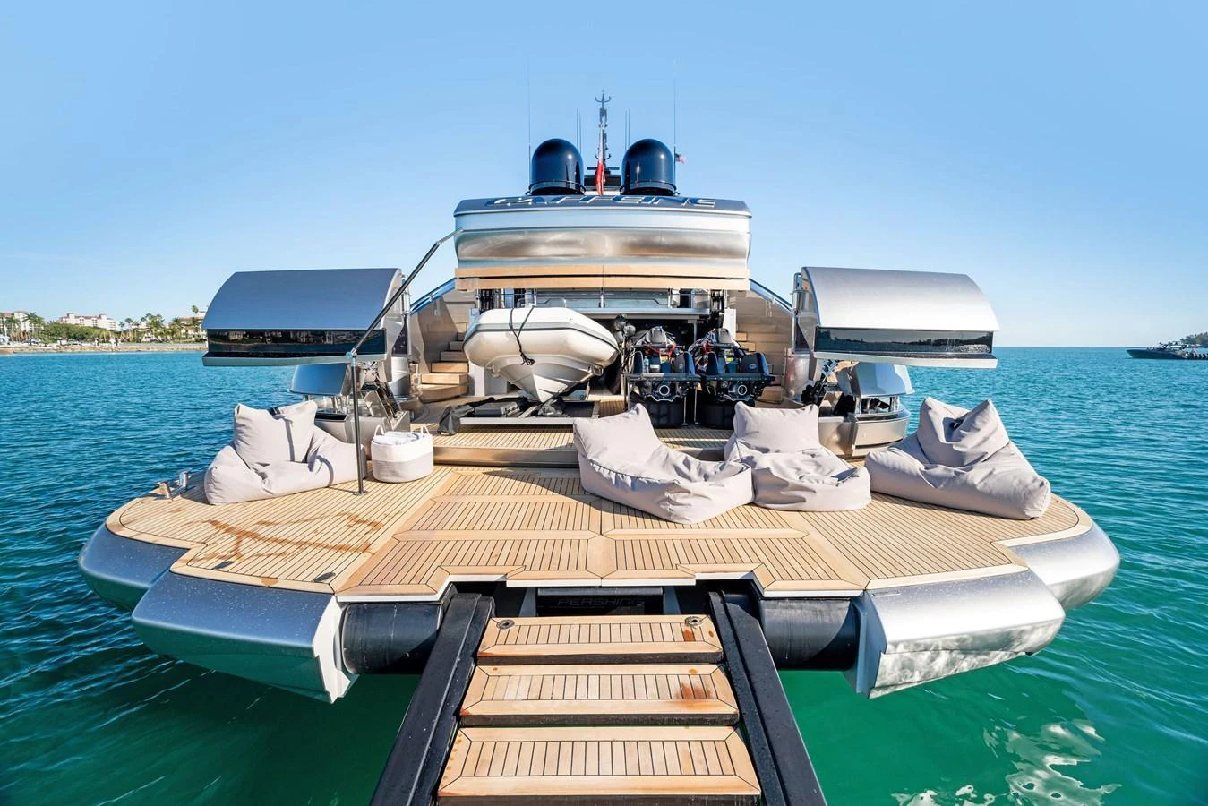 The aft deck of this yacht features a spacious lounging area with plush seating and easy access to the water. aboard CAFFEINE Yacht for Sale
