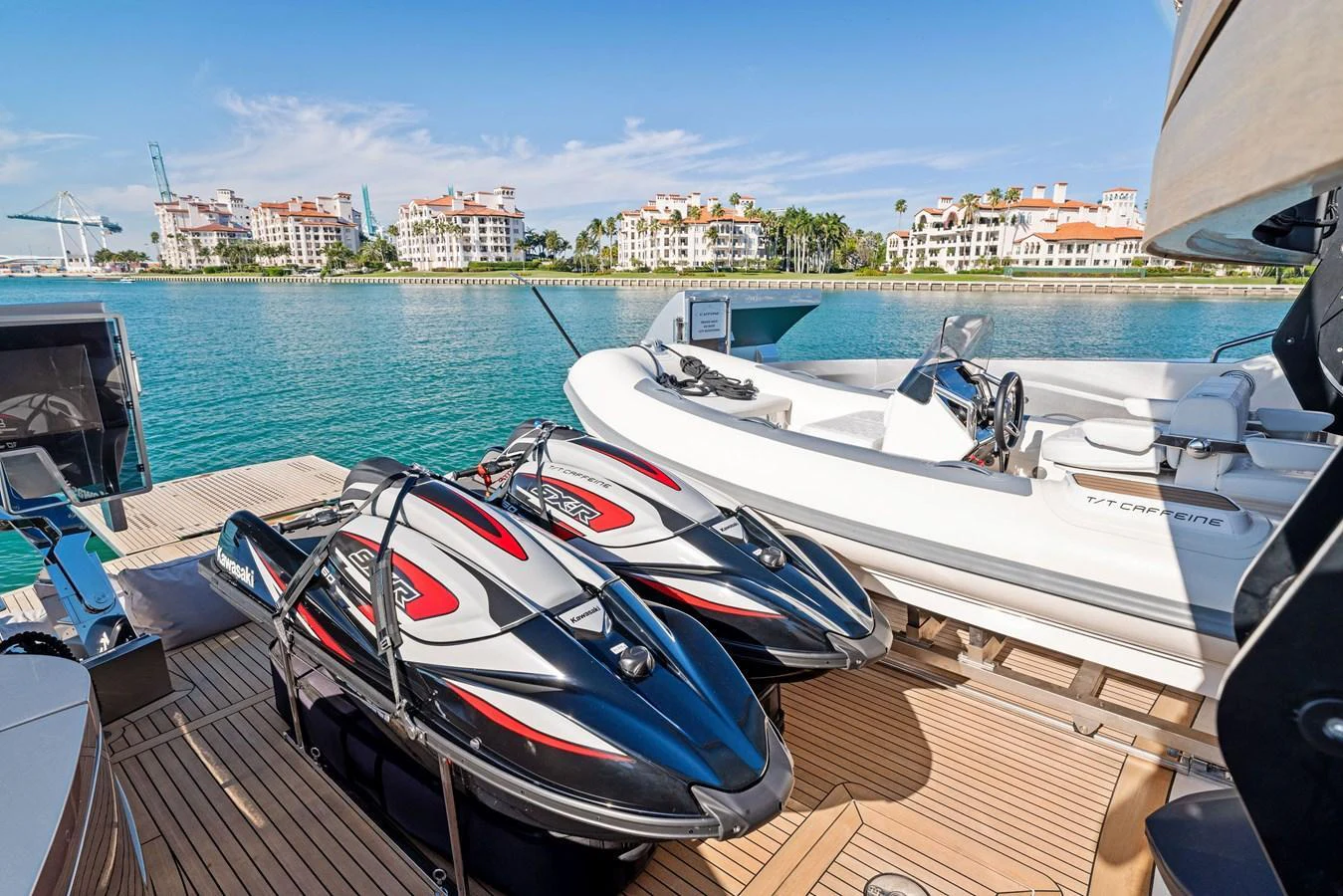 The yacht's deck features two sleek jet skis and a spacious tender, perfect for water adventures. aboard CAFFEINE Yacht for Sale