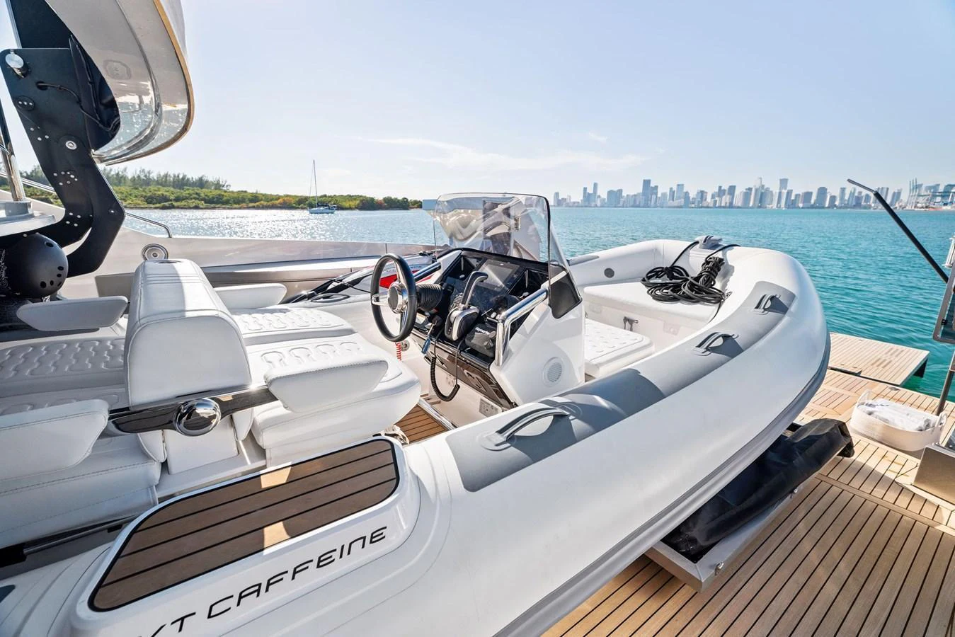 A sleek and modern tender is docked on the yacht's deck, ready for an adventure on the water. aboard CAFFEINE Yacht for Sale