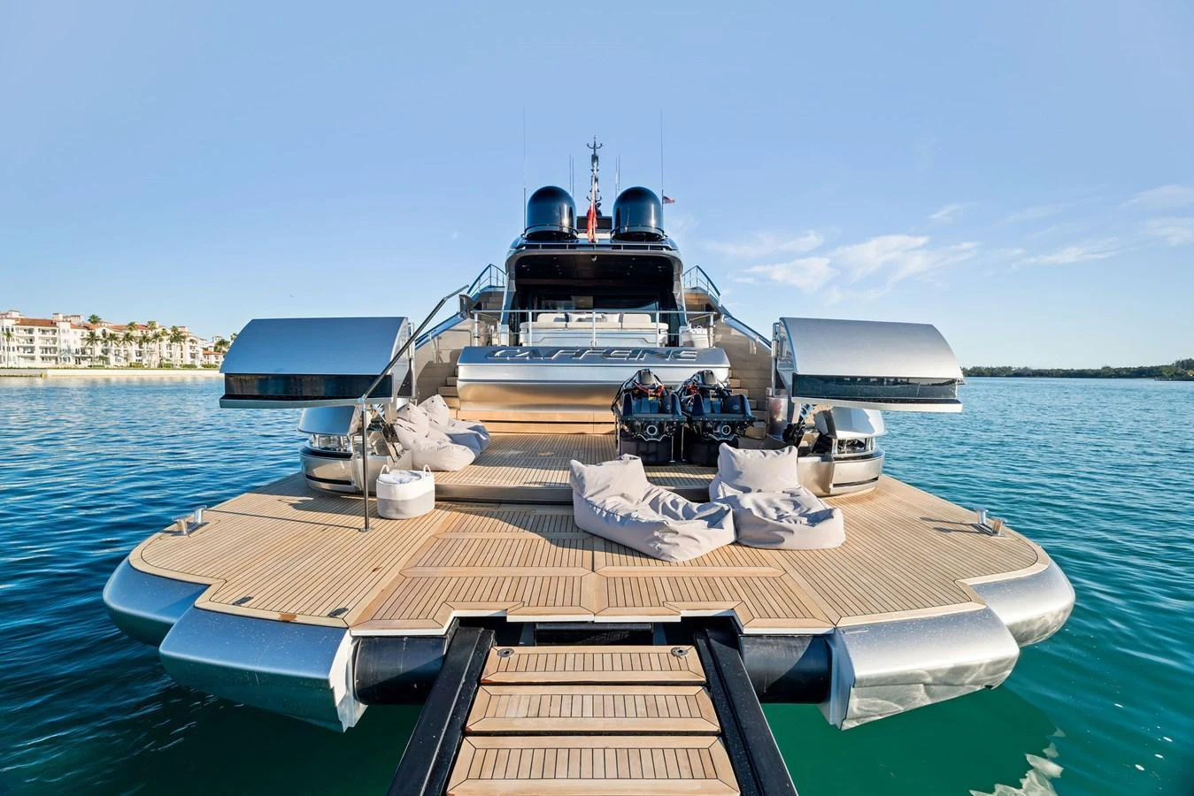 The yacht's expansive aft deck features luxurious lounging areas and direct access to the water. aboard CAFFEINE Yacht for Sale
