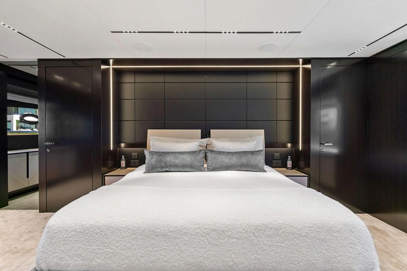 The master stateroom features a luxurious bed with elegant, modern decor. aboard CAFFEINE Yacht for Sale