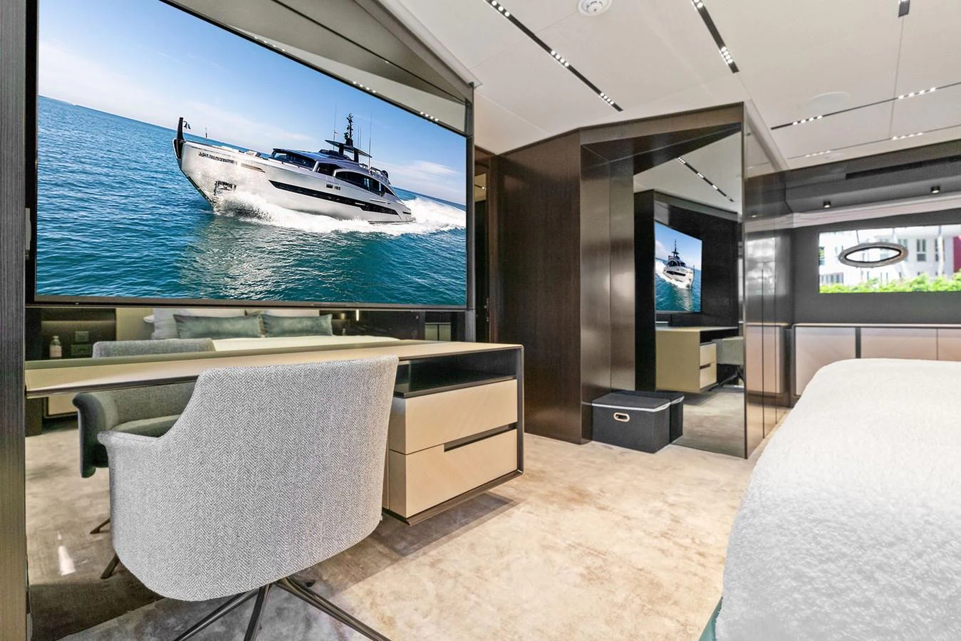 A luxurious stateroom featuring a large TV, modern furnishings, and elegant decor. aboard CAFFEINE Yacht for Sale