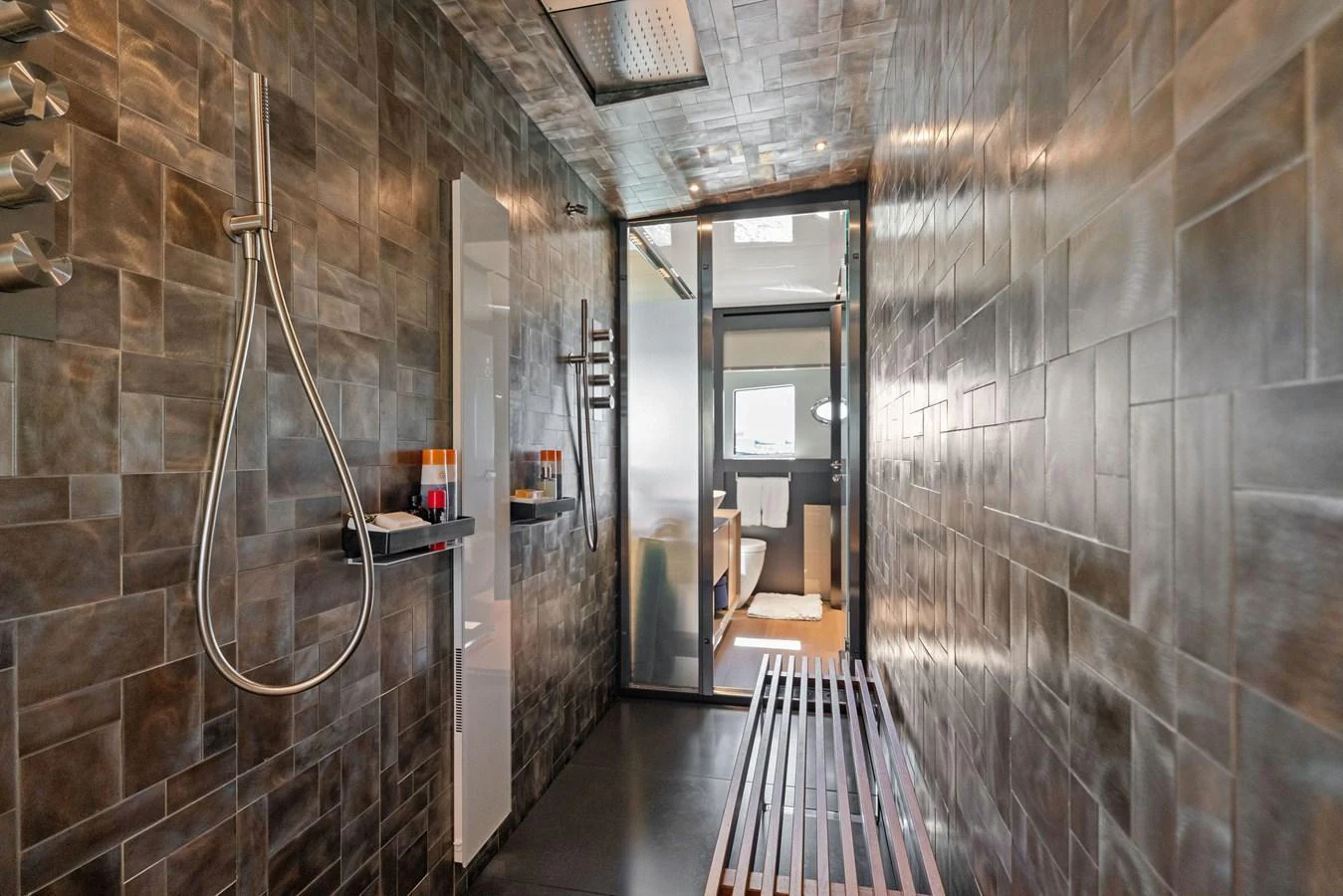 A sleek and modern yacht bathroom with a spacious shower area and contemporary fixtures. aboard CAFFEINE Yacht for Sale
