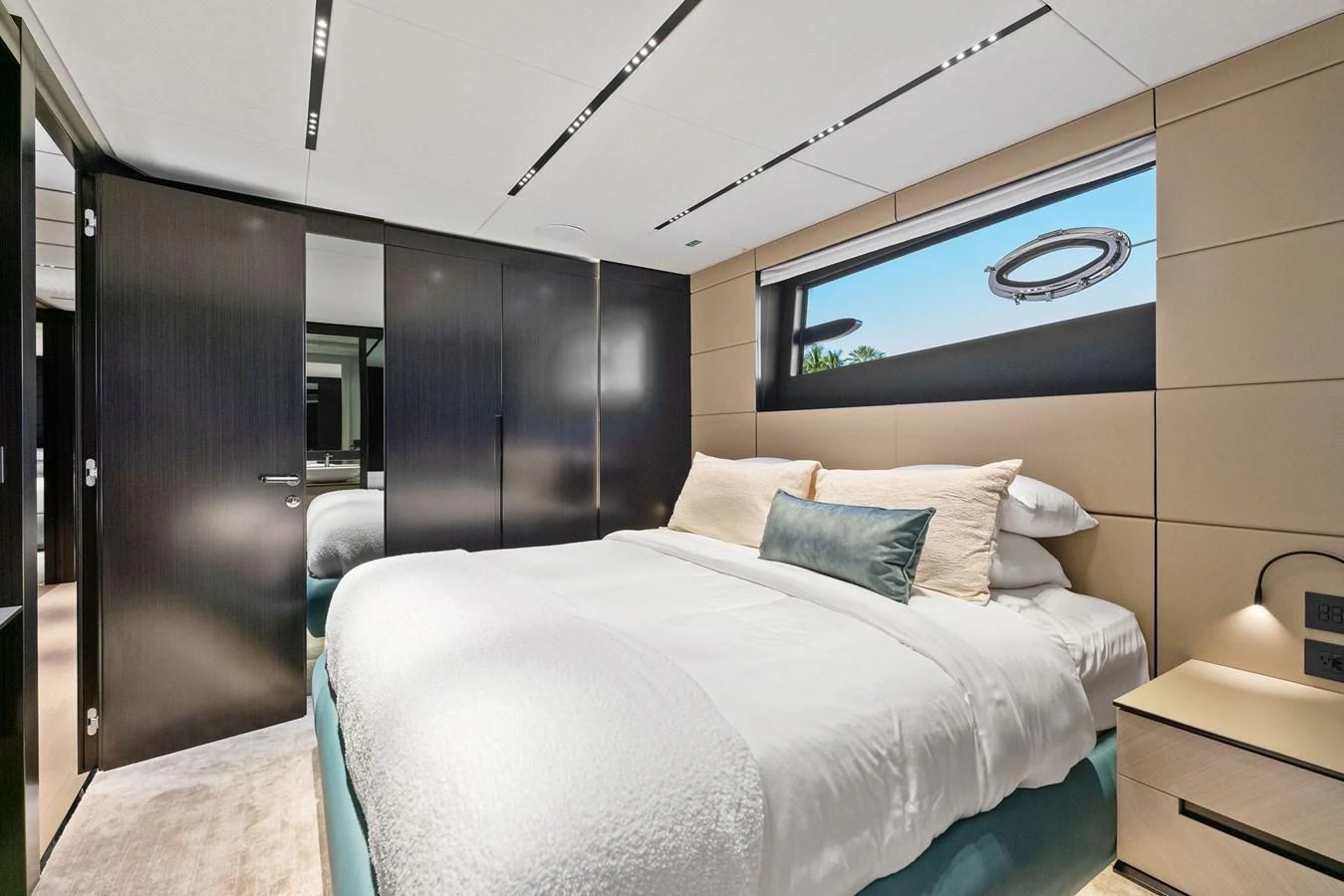 The stateroom features a plush bed with modern furnishings and ample natural light. aboard CAFFEINE Yacht for Sale