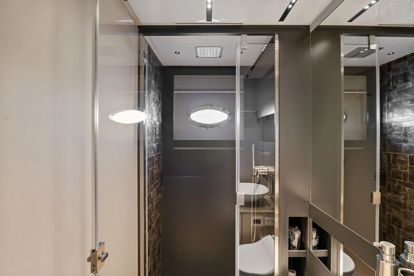 The yacht's bathroom features modern fixtures and a sleek design with a glass-enclosed shower. aboard CAFFEINE Yacht for Sale