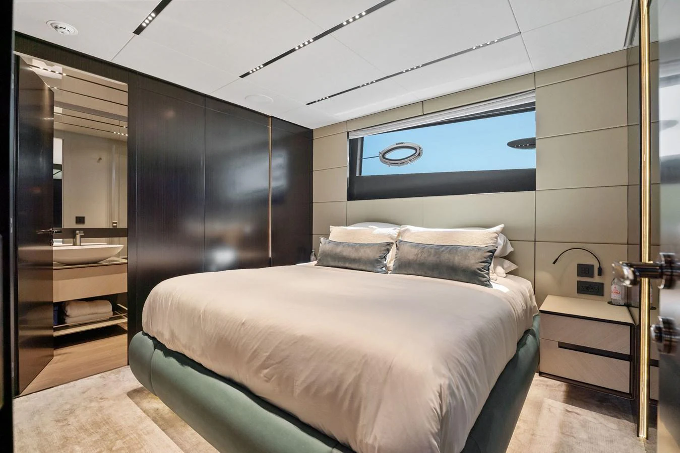 A luxurious stateroom featuring a plush bed and modern design elements. aboard CAFFEINE Yacht for Sale