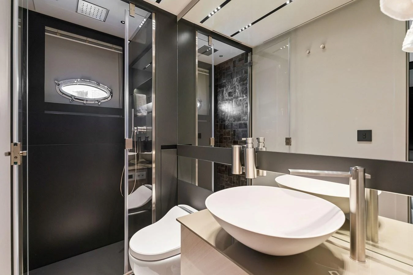 A modern yacht bathroom featuring sleek fixtures and a contemporary design. aboard CAFFEINE Yacht for Sale