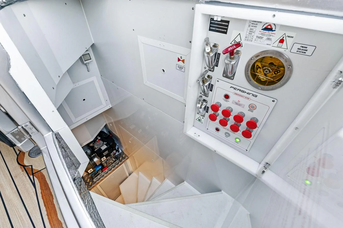 A detailed view of the yacht's control panel and stairway leading to the engine room. aboard CAFFEINE Yacht for Sale