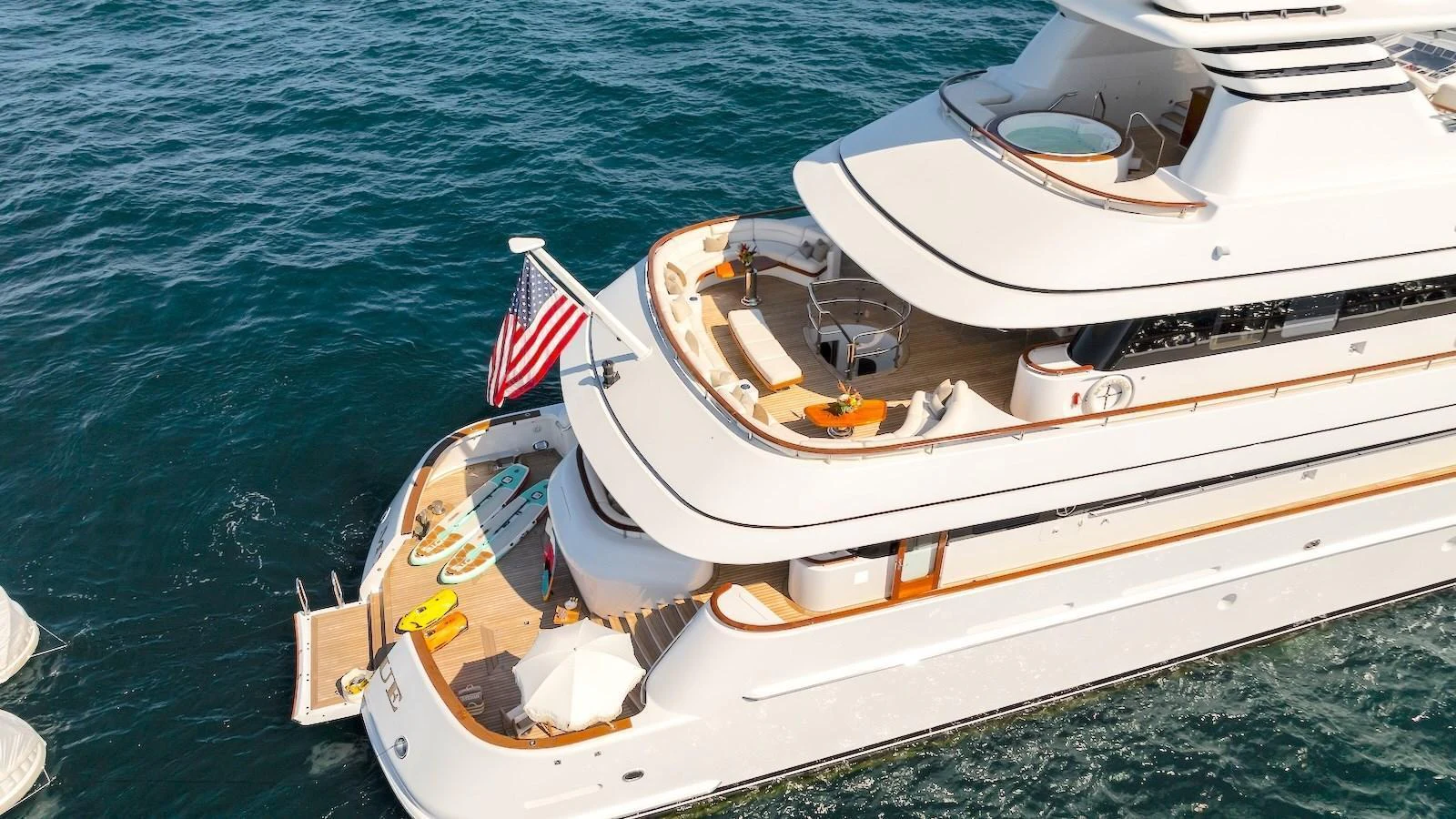 The yacht's aft deck features multiple levels with lounging areas and water toys, perfect for relaxation and fun on the water. aboard MYSTIQUE Yacht for Sale