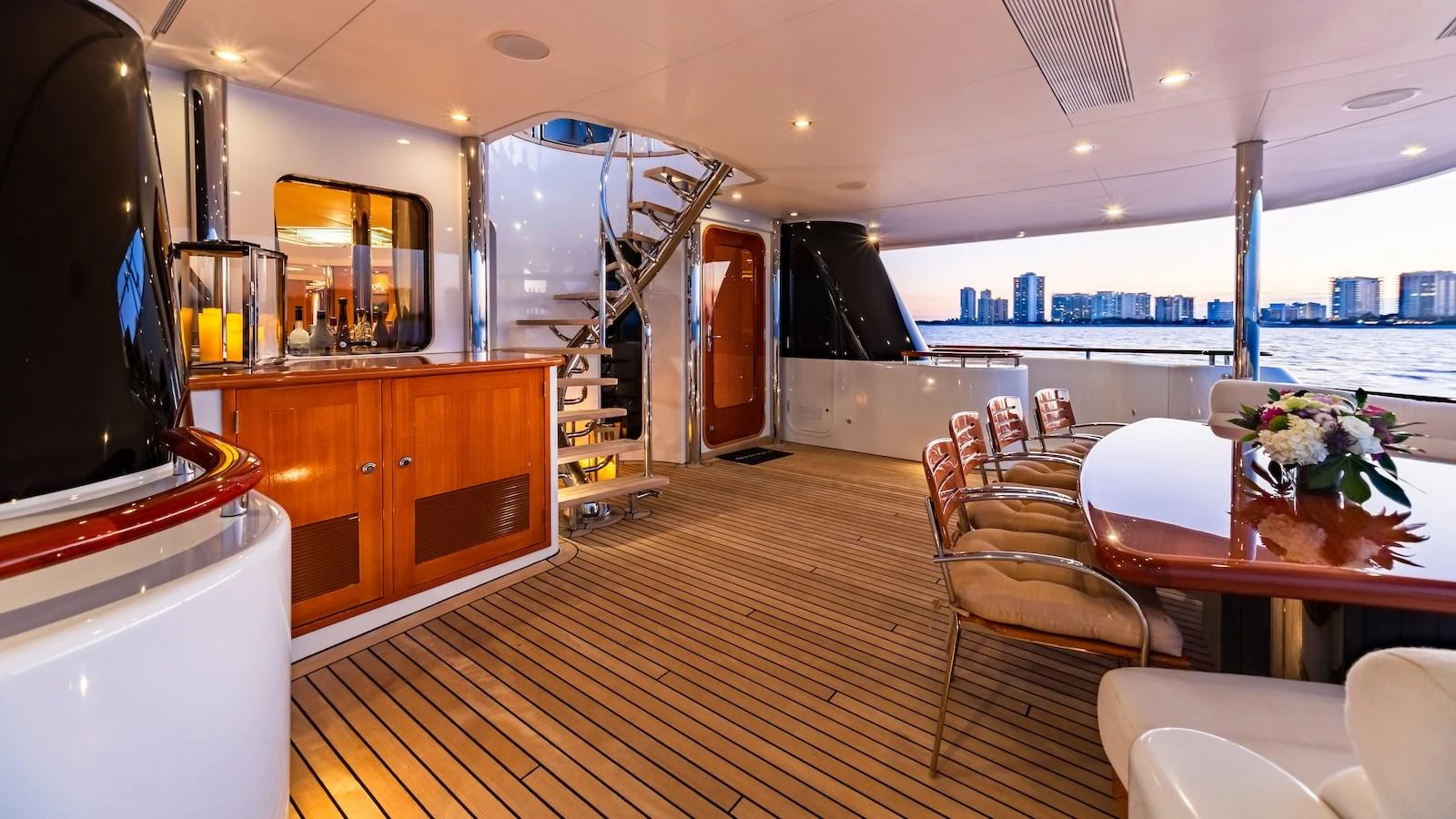 The aft deck features elegant seating and dining areas with a stunning view of the water. aboard MYSTIQUE Yacht for Sale