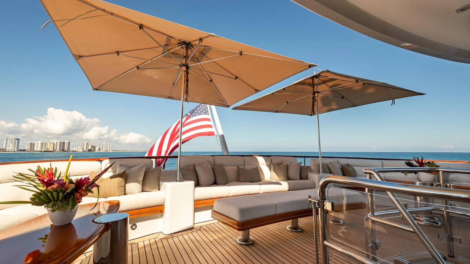 The aft deck features comfortable seating under large umbrellas, perfect for enjoying the ocean views. aboard MYSTIQUE Yacht for Sale