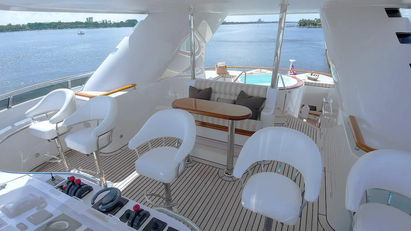 The flybridge offers a luxurious outdoor seating area with stunning views of the water. aboard MYSTIQUE Yacht for Sale