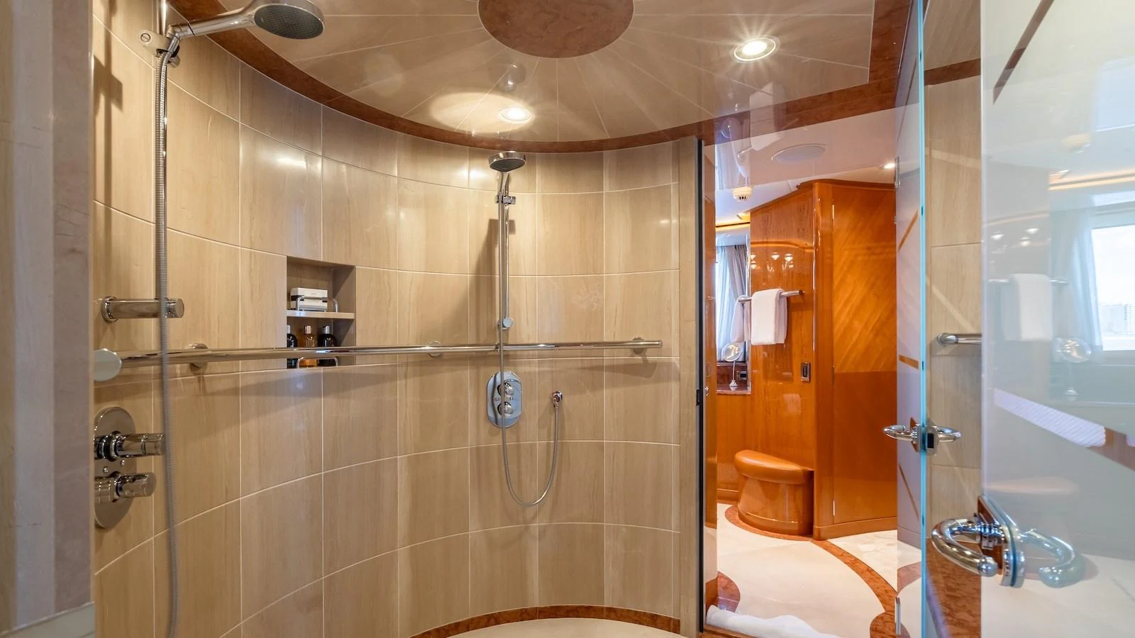 The yacht's bathroom features a spacious, elegantly designed shower area with modern fixtures. aboard MYSTIQUE Yacht for Sale