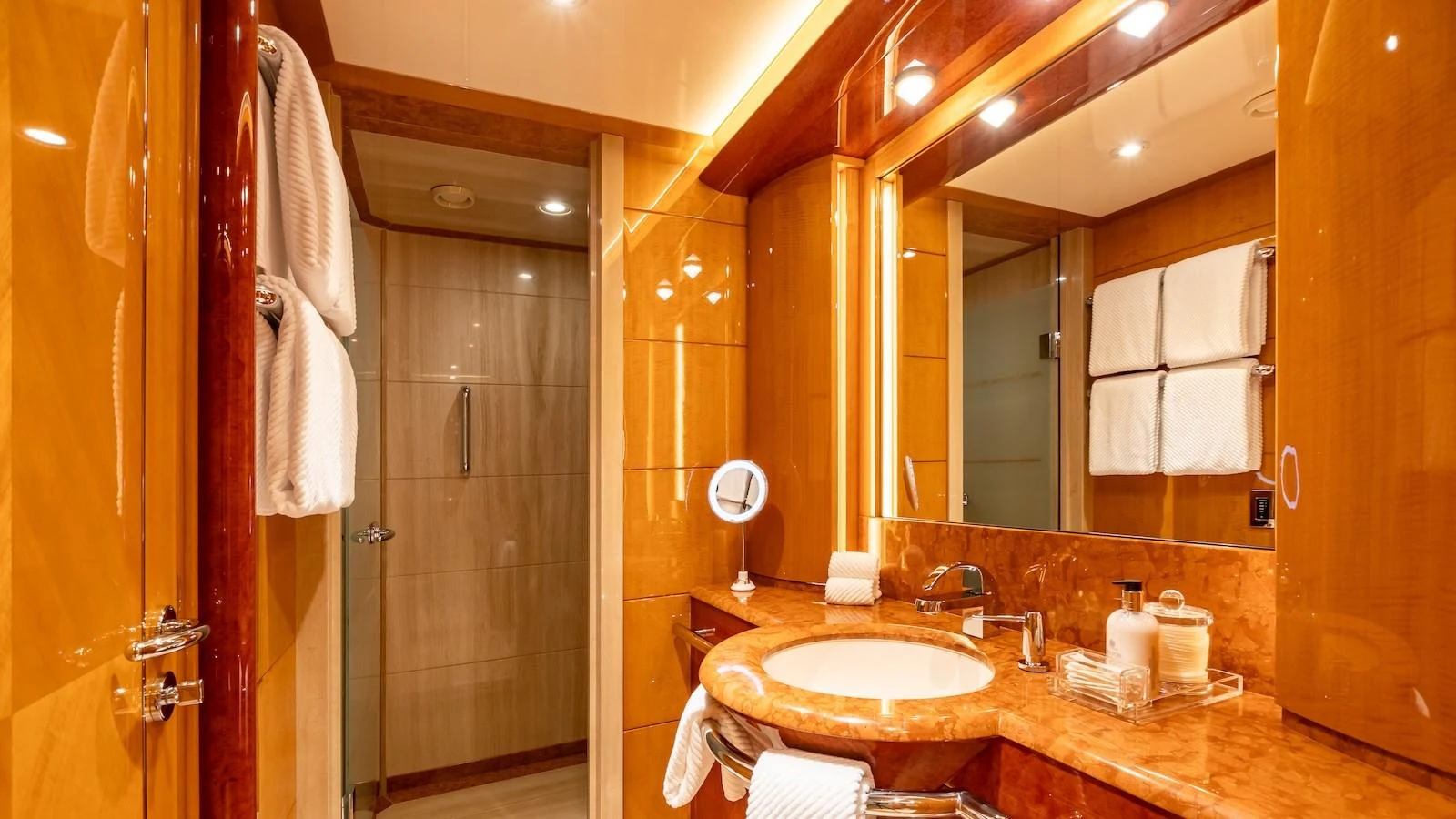 The yacht's bathroom features luxurious wood paneling and elegant fixtures. aboard MYSTIQUE Yacht for Sale