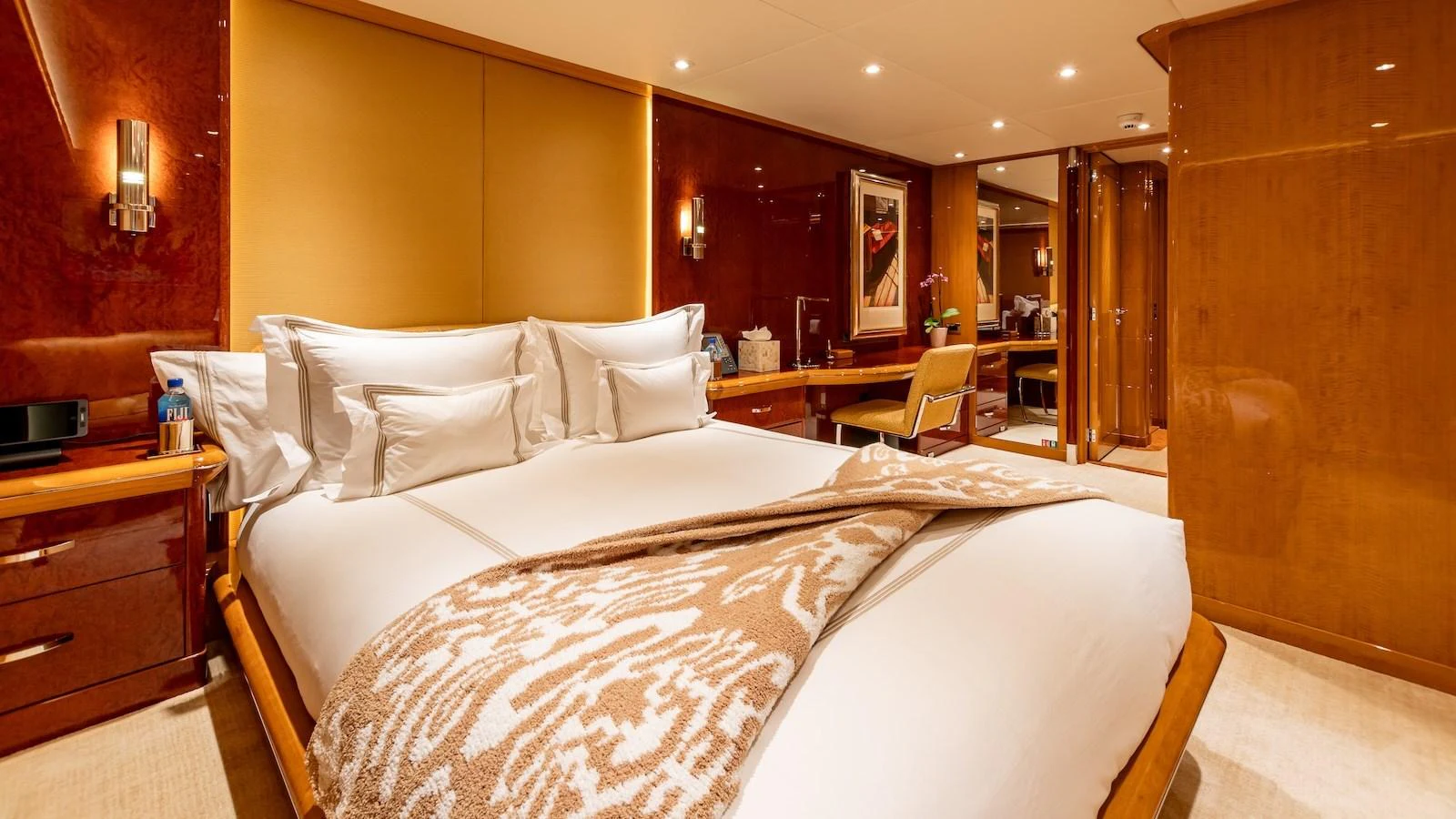 The master stateroom features a luxurious bed with elegant decor and ample lighting. aboard MYSTIQUE Yacht for Sale
