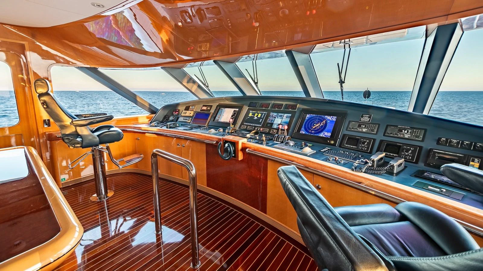 The helm station offers a sophisticated and technologically advanced command center with panoramic ocean views. aboard MYSTIQUE Yacht for Sale