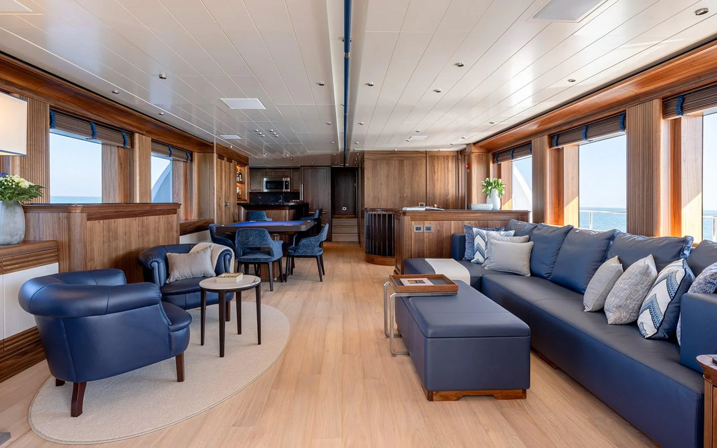 The yacht's salon features luxurious seating with elegant wood paneling and ample natural light. aboard EMPIRE Yacht for Sale