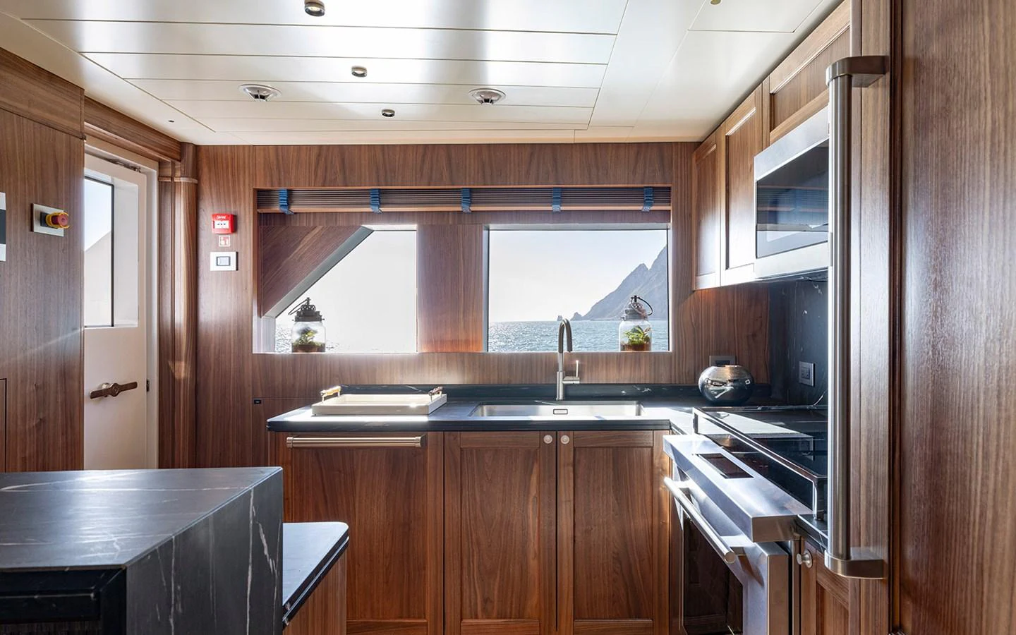 The galley features modern appliances and a stunning view through large windows. aboard EMPIRE Yacht for Sale
