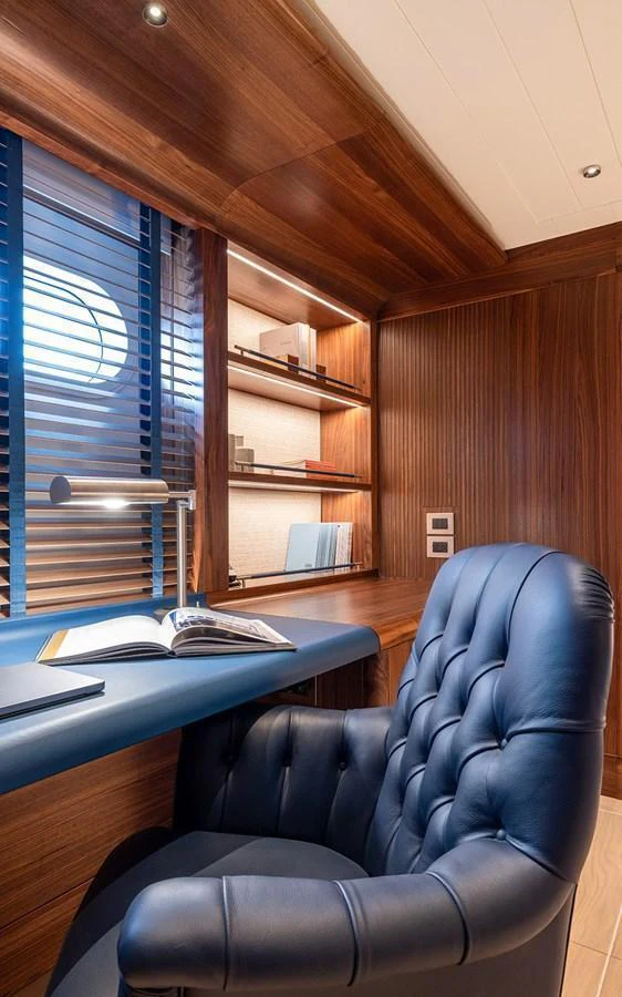 The yacht's office features a luxurious leather chair and a well-appointed desk with ample shelving. aboard EMPIRE Yacht for Sale