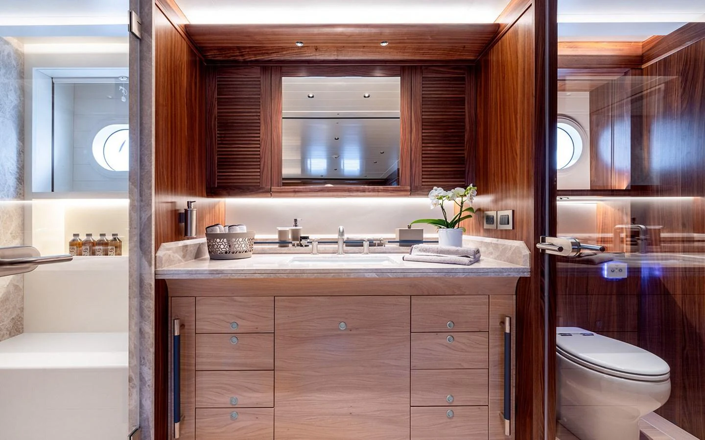 The yacht's bathroom features elegant wood finishes and modern fixtures, creating a luxurious and serene atmosphere. aboard EMPIRE Yacht for Sale