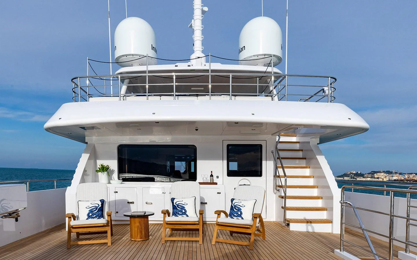 The aft deck features comfortable seating and a serene view of the ocean. aboard EMPIRE Yacht for Sale