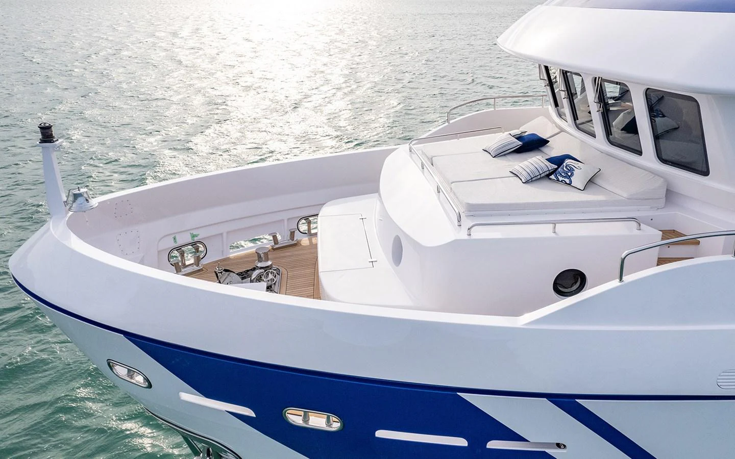 The yacht's foredeck features a spacious sunbathing area with plush cushions and a sleek design. aboard EMPIRE Yacht for Sale