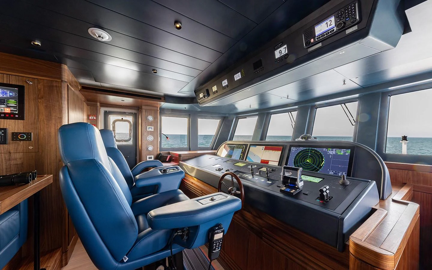 The helm station features advanced navigation equipment and comfortable seating with a panoramic view of the sea. aboard EMPIRE Yacht for Sale