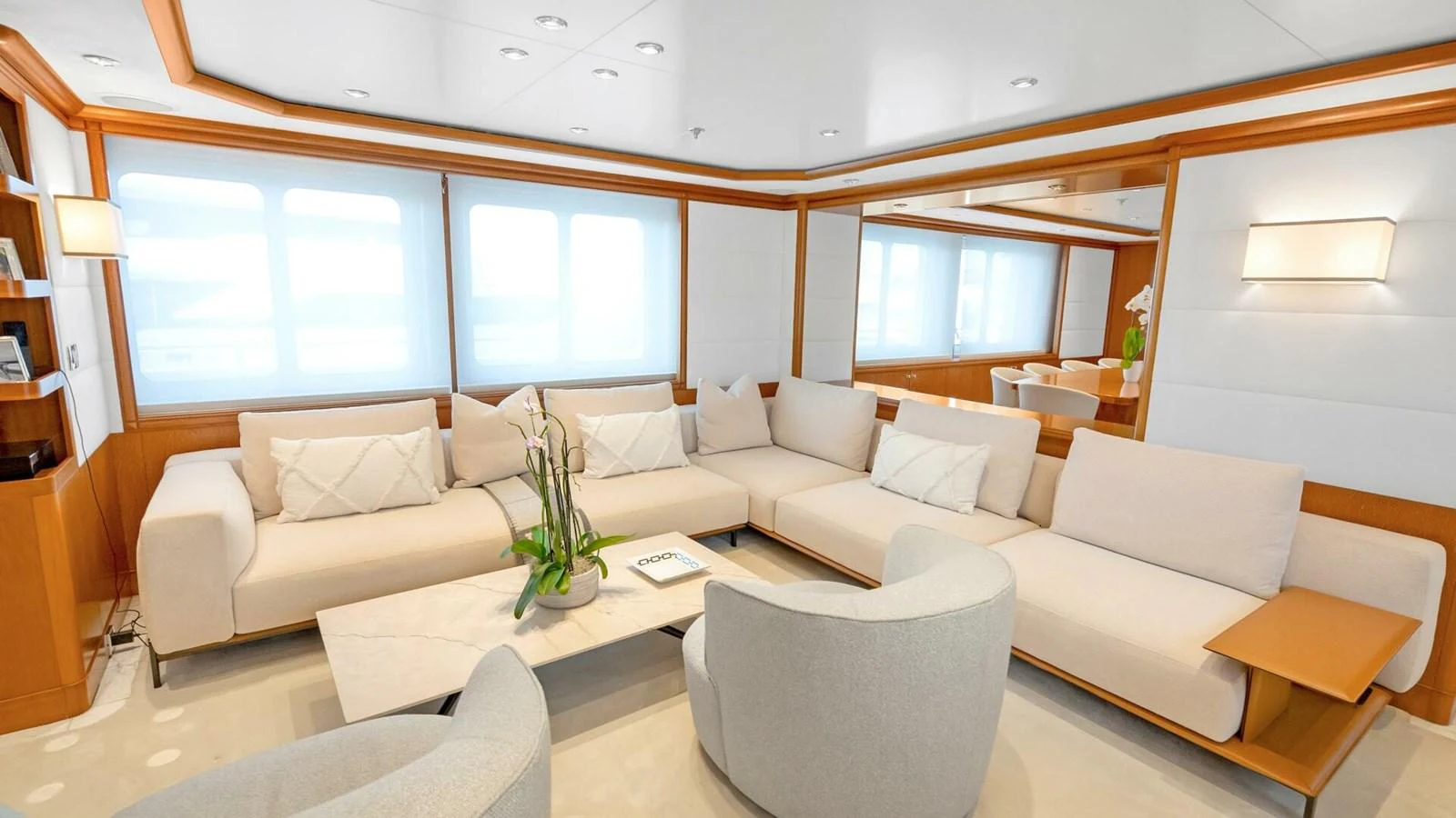 a living room with white couches aboard UNFORGETTABLE Yacht for Sale
