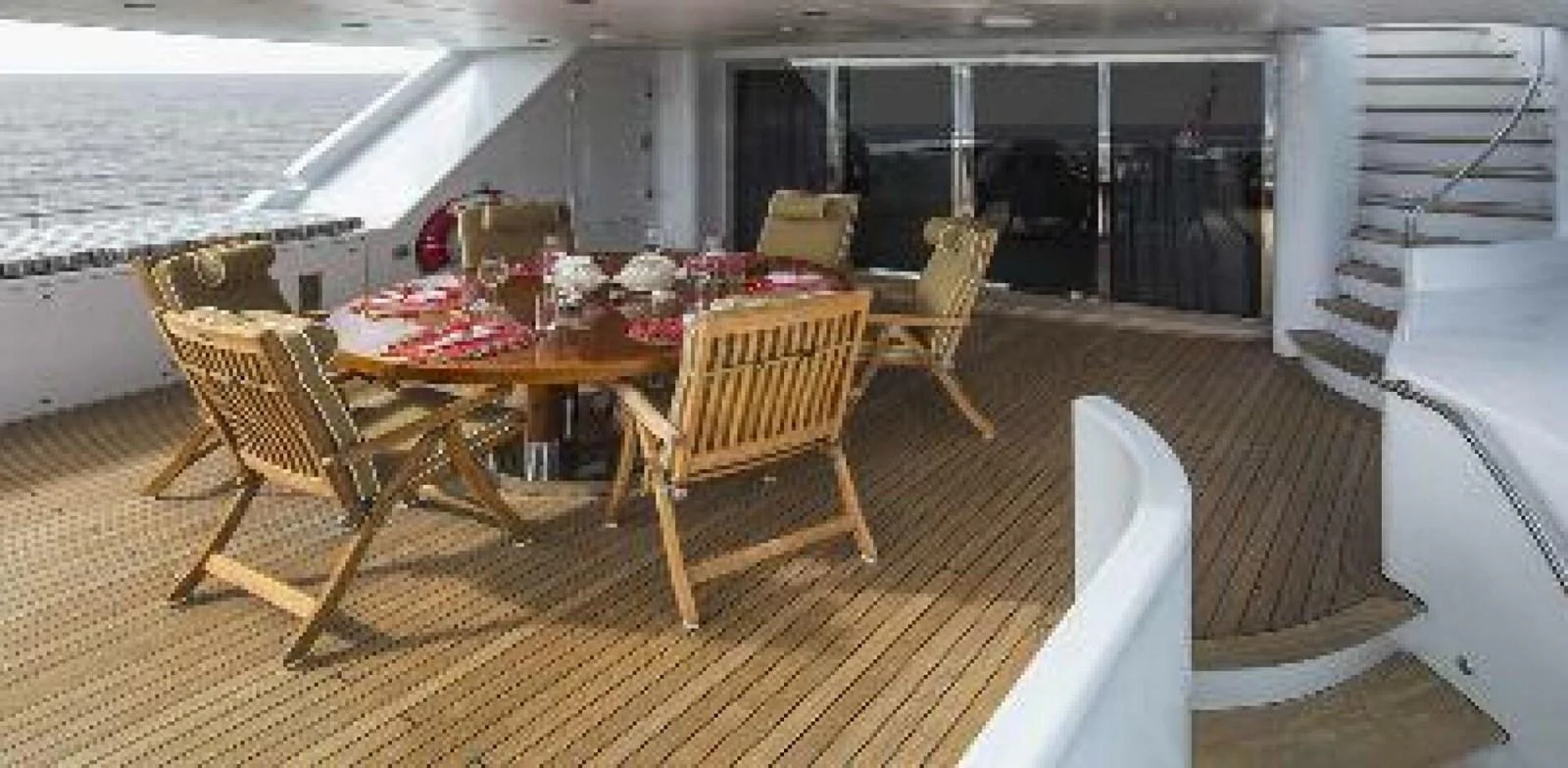 a deck with chairs and tables aboard UNFORGETTABLE Yacht for Sale