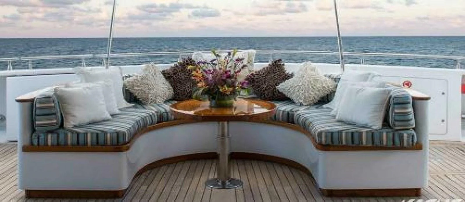 a couch and table on a deck aboard UNFORGETTABLE Yacht for Sale