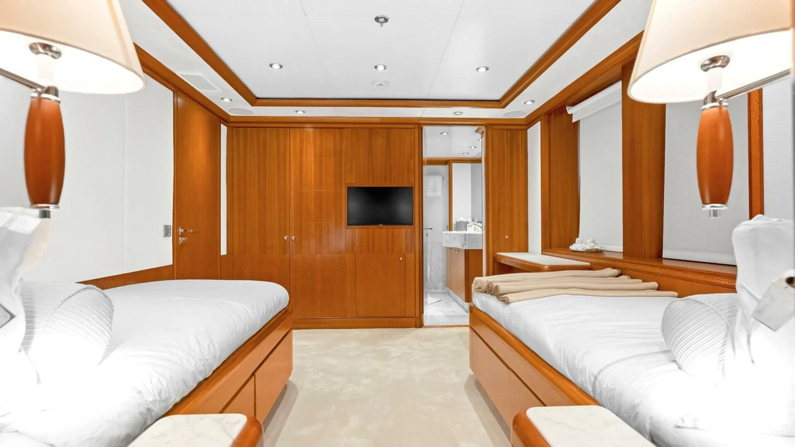 a room with a bed and a television aboard UNFORGETTABLE Yacht for Sale