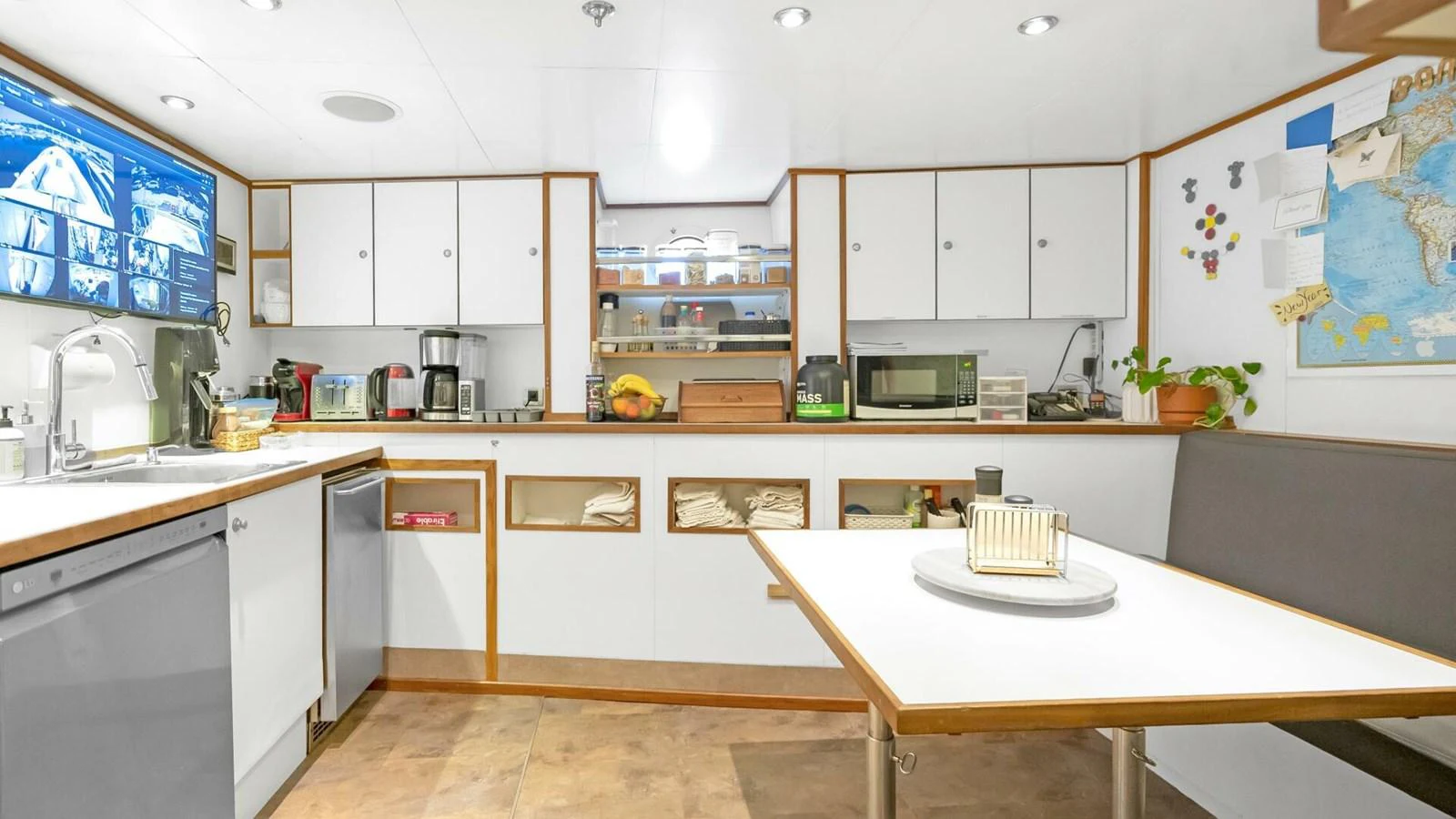 a kitchen with white cabinets aboard UNFORGETTABLE Yacht for Sale