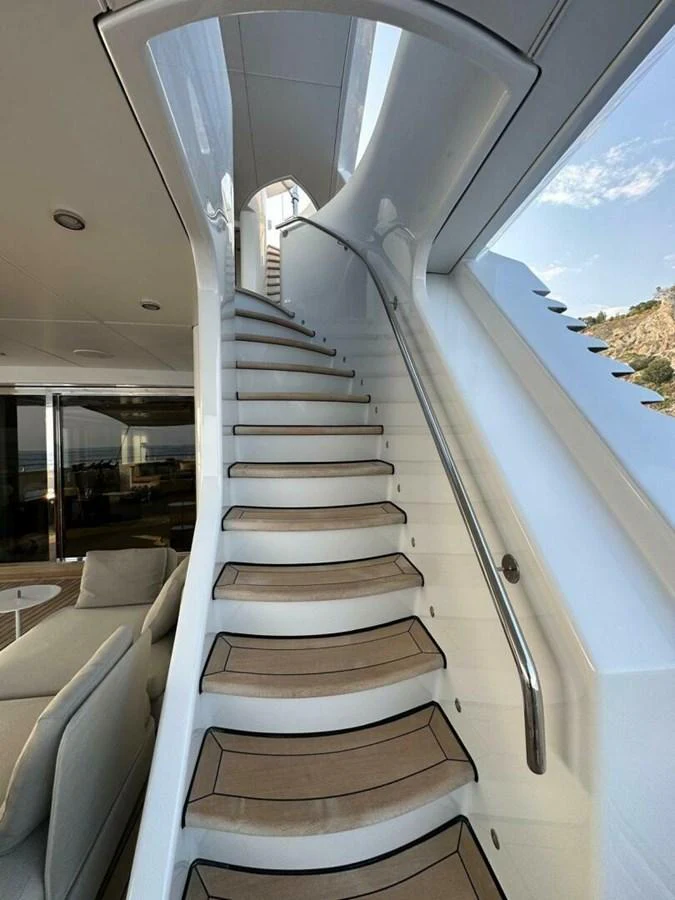 a white staircase with a railing aboard UNFORGETTABLE Yacht for Sale