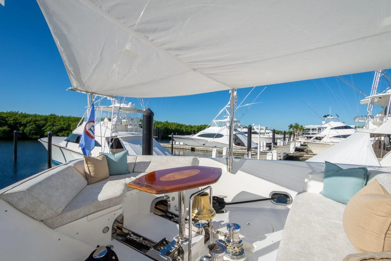 The flybridge offers a comfortable seating area with a shaded canopy, perfect for relaxation and enjoying the view. aboard LUCKY PENNY Yacht for Sale